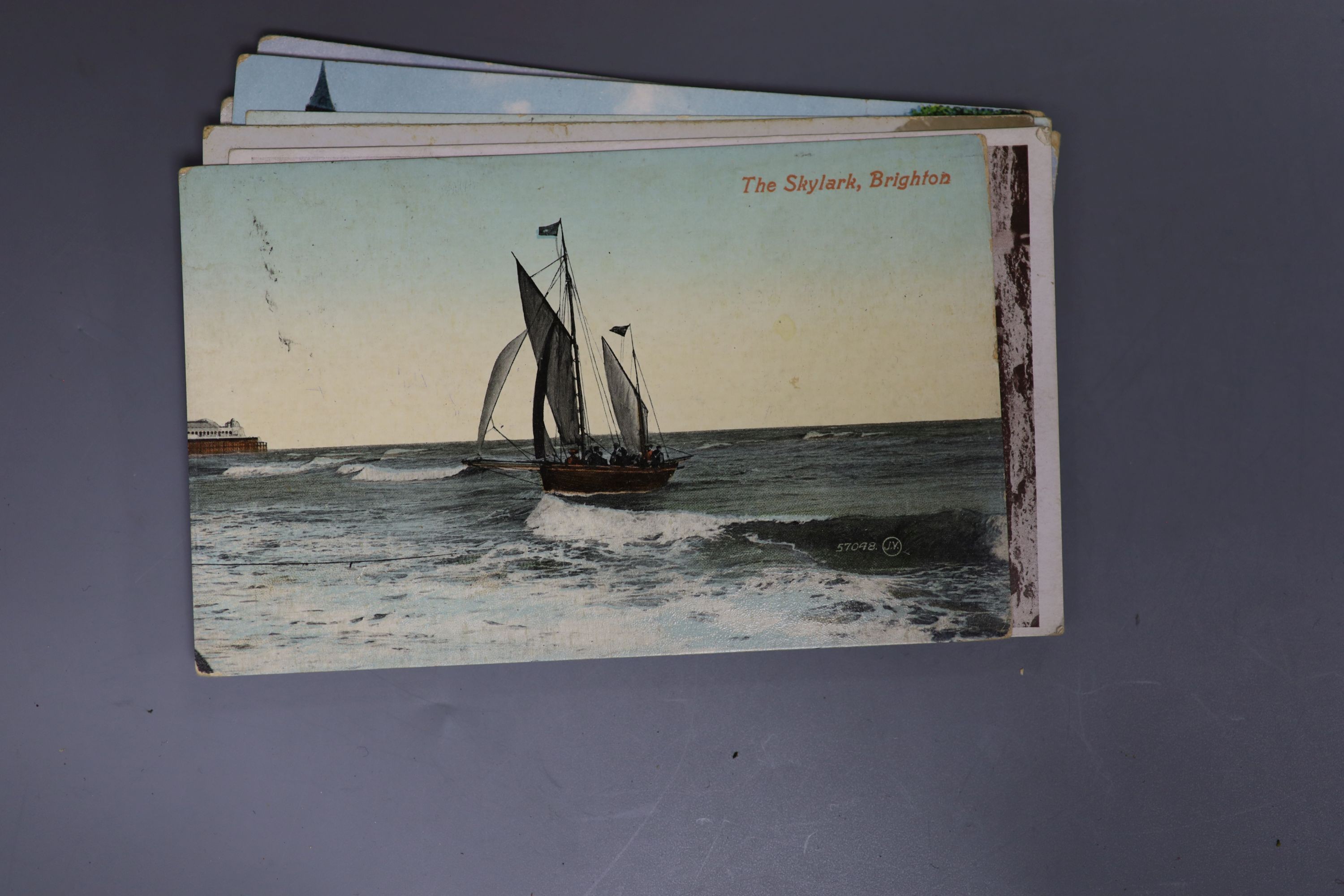 An album of Edwardian and later postcards, including Brighton and Sussex views